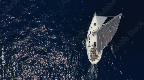 Aerial photo of sail boat cruising open ocean deep blue sea © aerial-drone
