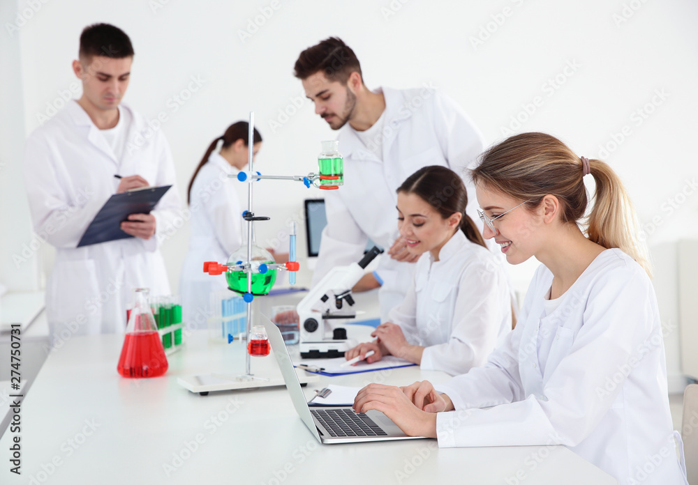 Medical students working in modern scientific laboratory Medical students working in modern scientific laboratory