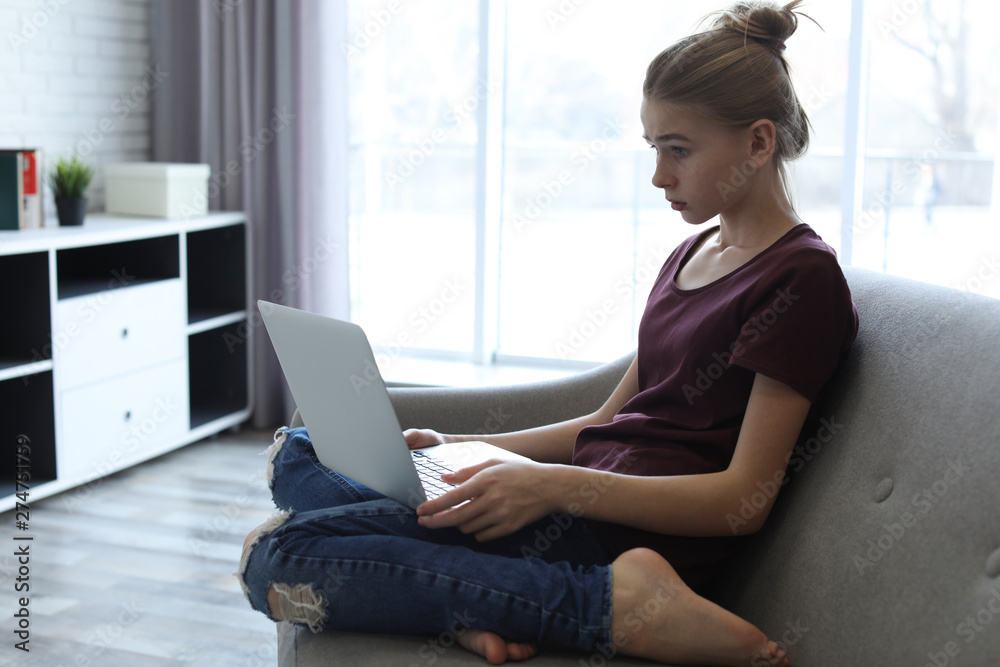 Shocked teenage girl with laptop in room. Danger of internet Shocked teenage girl with laptop in room. Danger of internet