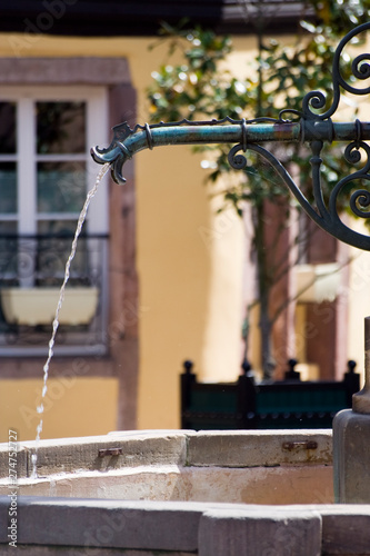 Water flowing from a fountain with telelenses (Alsace - France)
