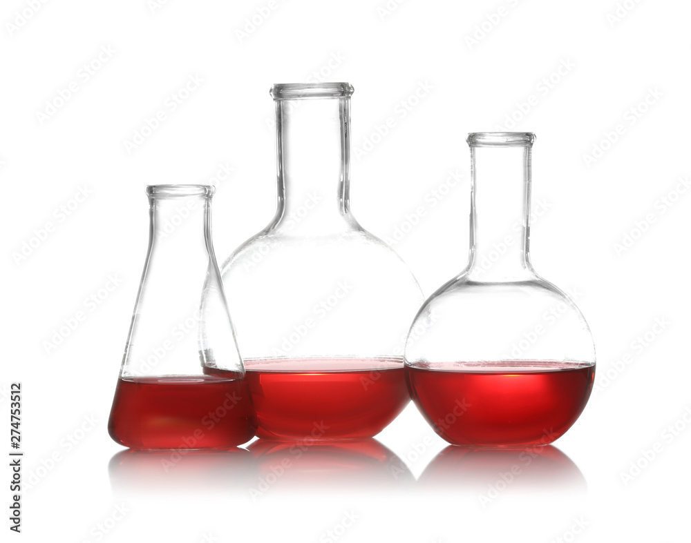 Group of chemistry glassware with liquid samples isolated on white Group of chemistry glassware with liquid samples isolated on white