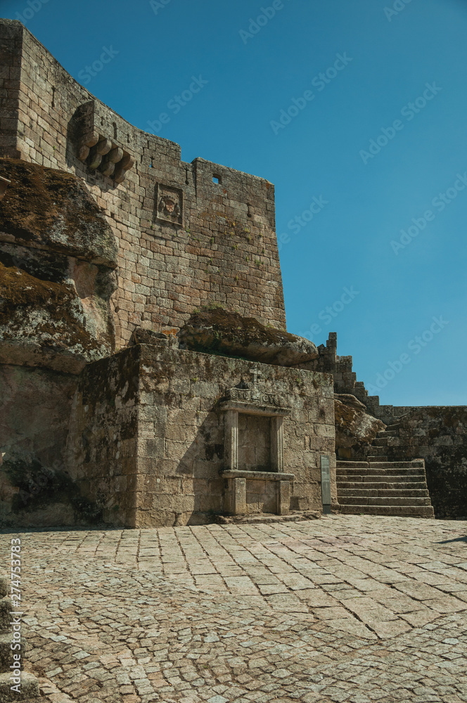 Stone castle facade with staircase and gateway