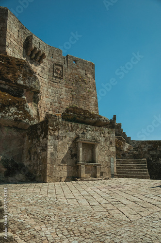 Stone castle facade with staircase and gateway