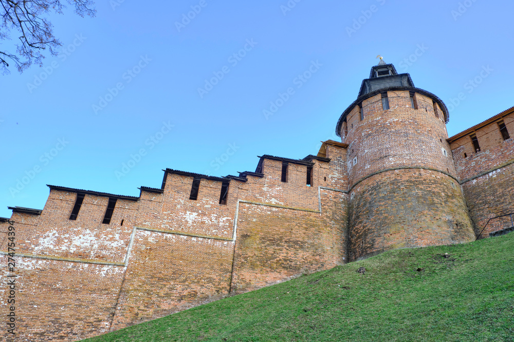 Scenic view of old wall of kremlin in historic center of Nizhniy Novgorod. Beautiful sunny summer look of wall with towers of red bricks in ancient touristic city in Russian Federation