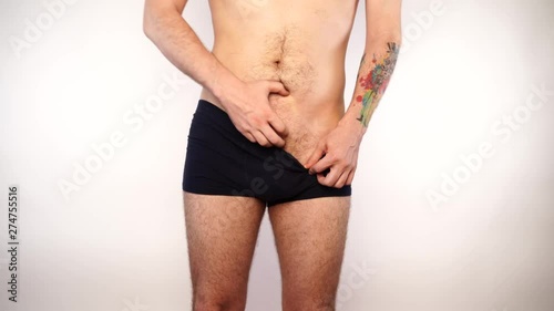 Man scratching crotch on white background, closeup. Annoying itch
