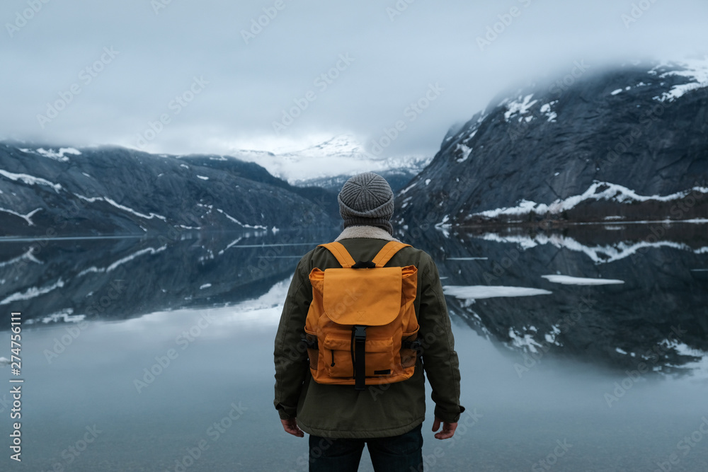 travel and adventure background, hiker with backpack enjoying landscape in Lofoten, Norway