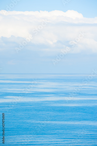 Blue sea and sky with white clouds. Beautiful nature background