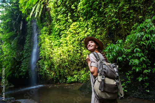 Woman near waterfal on Bali, Indonesia 