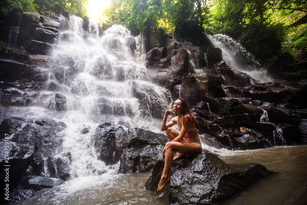 Woman near waterfal on Bali, Indonesia Woman near waterfal on Bali, Indonesia