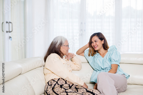 Beautiful woman chats with her mother at home