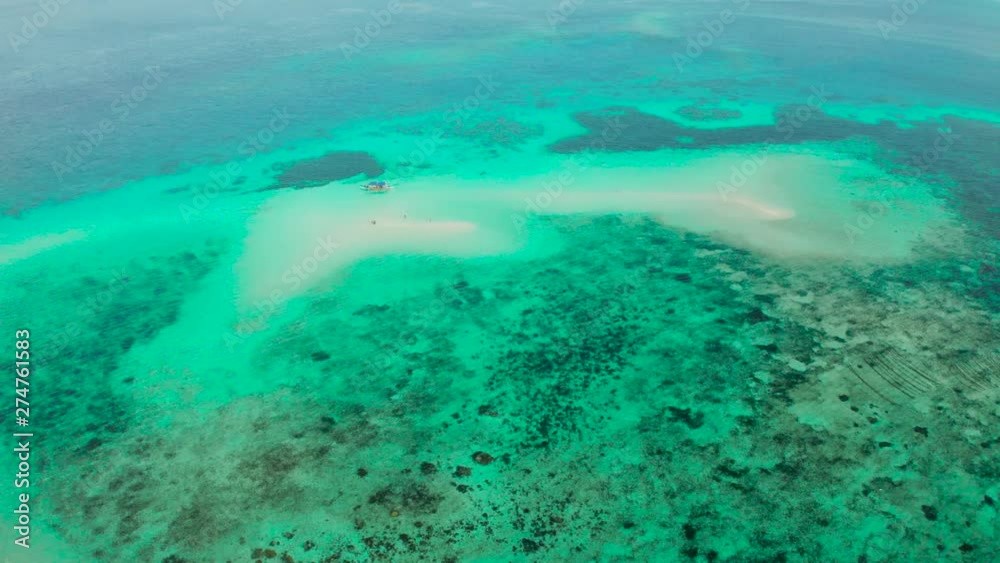Sand bar among coral reefs, aerial view. Small sandy beach on a coral atoll in turquoise water. Summer and travel vacation concept. Balabac, Palawan, Philippines. Sand bar among coral reefs, aerial view. Small sandy beach on a coral atoll in turquoise water. Summer and travel vacation concept. Balabac, Palawan, Philippines.