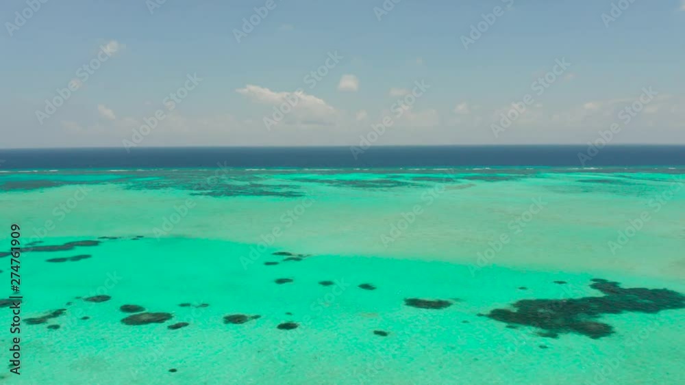 Atoll with coral reef and turquoise water against the sky with clouds top view. Summer and travel vacation concept. Balabac, Palawan, Philippines Atoll with coral reef and turquoise water against the sky with clouds top view. Summer and travel vacation concept. Balabac, Palawan, Philippines