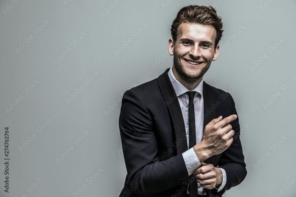 Portrait of a smiling handsome model in a classic black and white style clothing. Studio shot. Copy space. Portrait of a smiling handsome model in a classic black and white style clothing. Studio shot. Copy space.