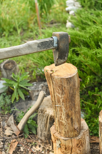 The process of cutting wood with a cleaver. Axe in the log