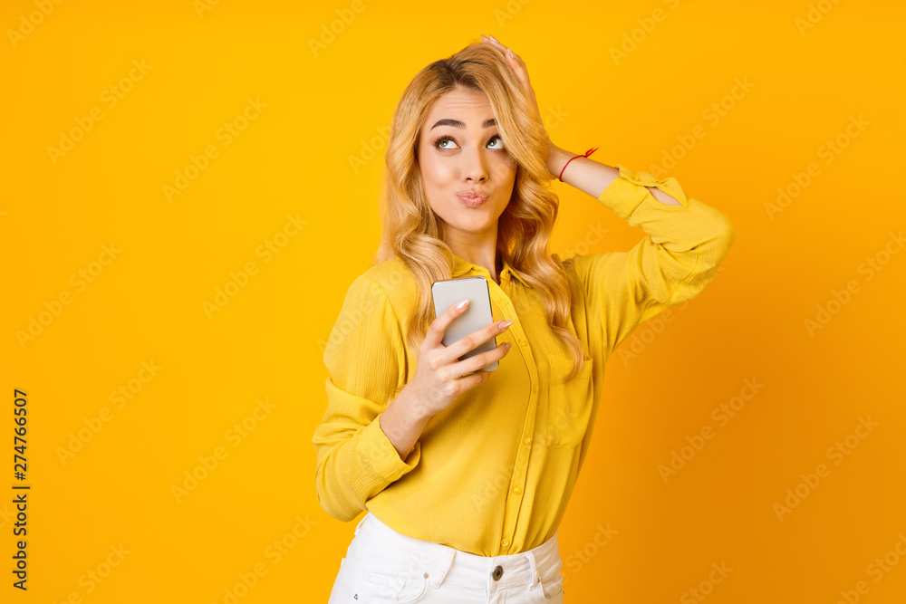 Thoughtful Woman Using Cellphone And Looking Up