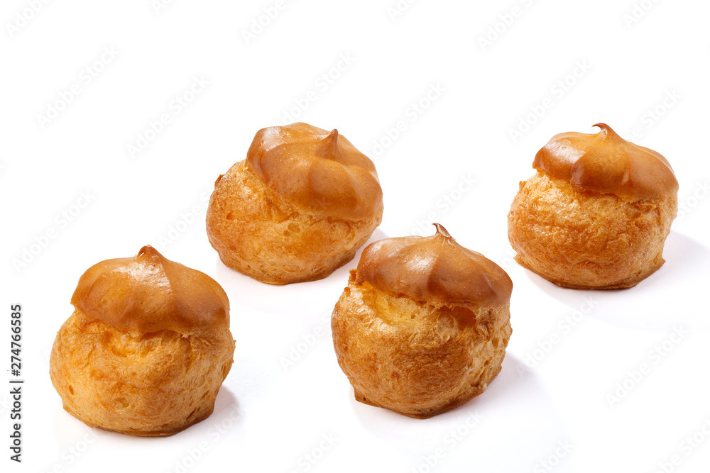 Profiterole or eclair, homemade sweets, close-up, isolated on white background.