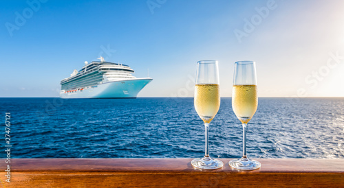 Photography Two glasses of champagne on wooden railing at sunset