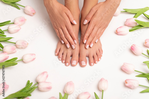 Female hands and feet with perfect done pedicure.