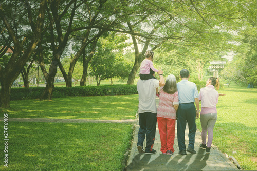 Multi generation family walks in the park