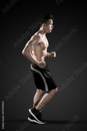 Muscled young man doing run exercises