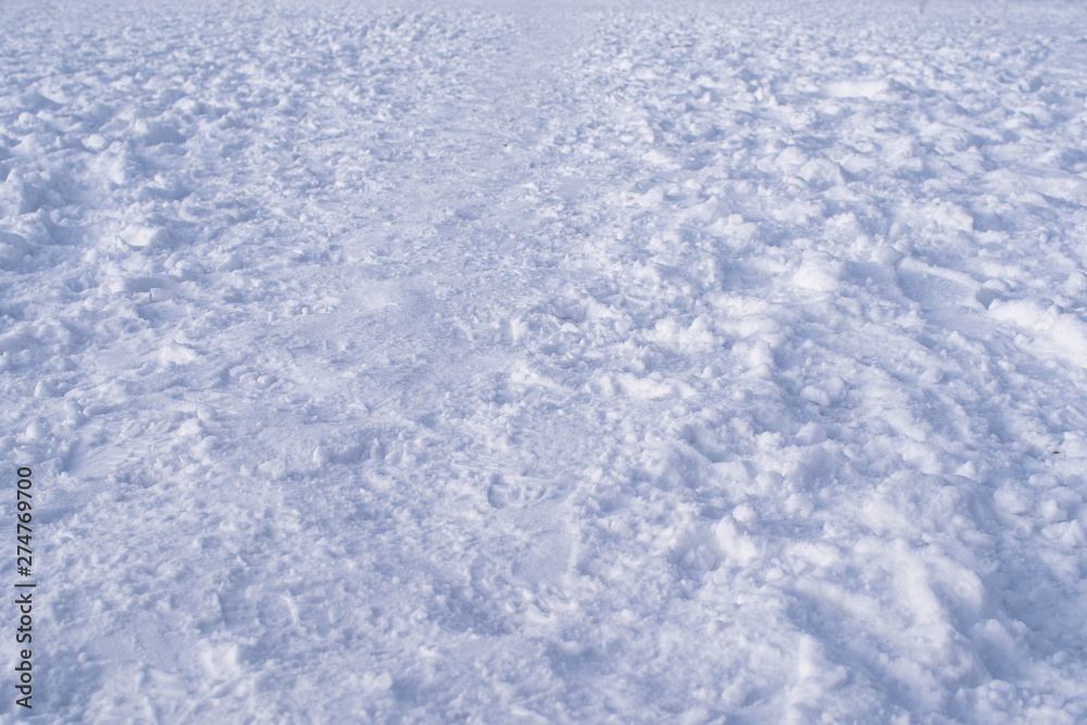 numerous footprints in the snow create a winter background