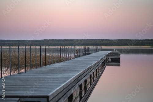 Wallpaper Mural The concept of leisure, a wooden pier on the background of the lake and sunset sky Torontodigital.ca