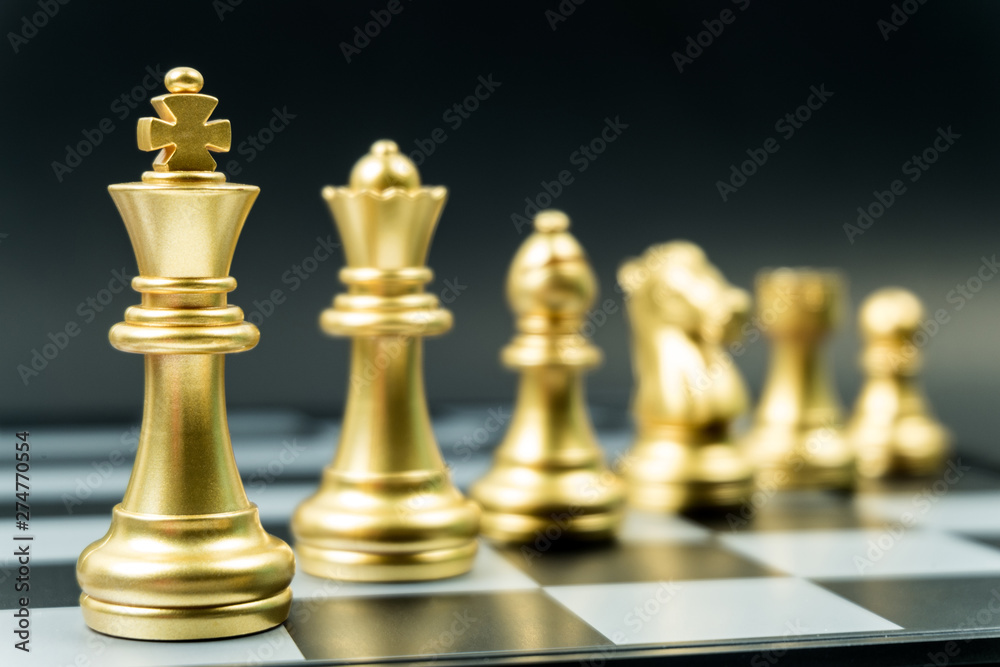 Row of gold chess team on board , black background Row of gold chess team on board , black background