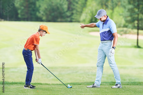 Boy playing golf in summer