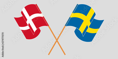 Crossed and waving flags of Sweden and Denmark