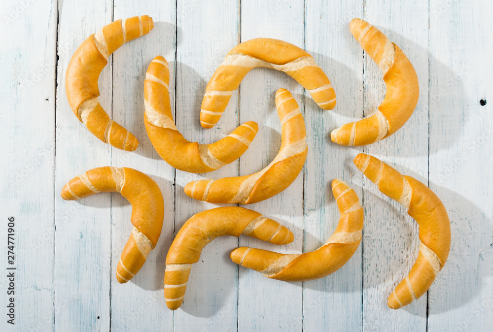 crescent rolls on white wooden table, directly above crescent rolls on white wooden table, directly above