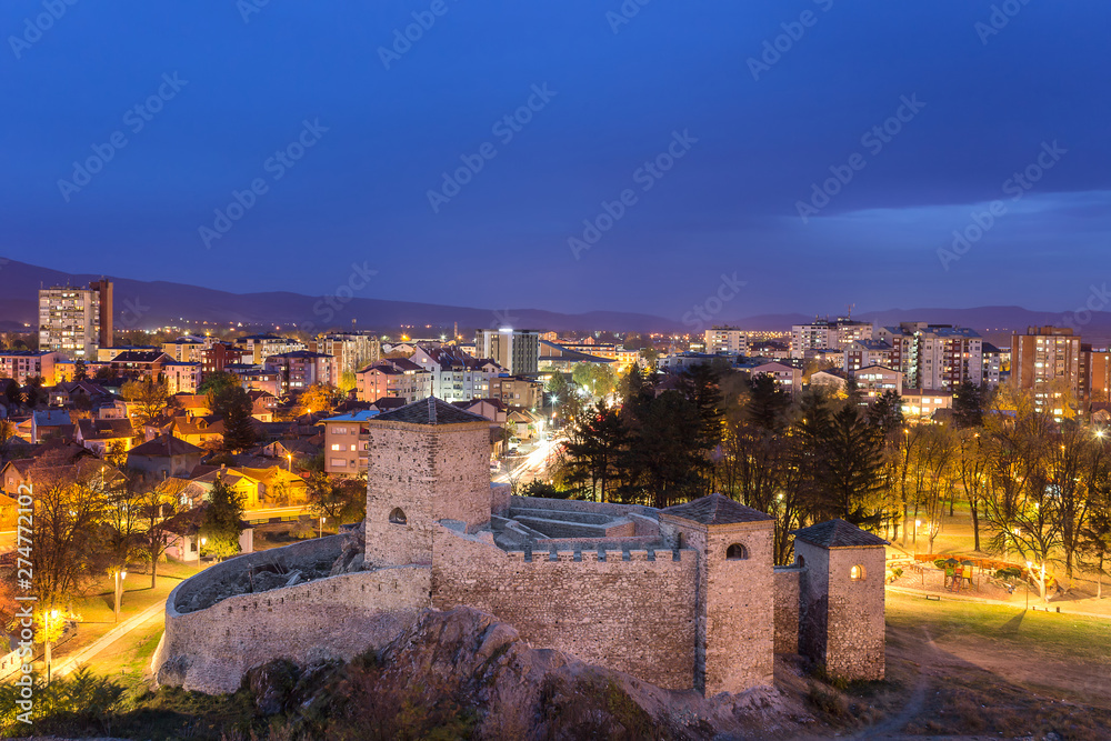 Blue hour view of ancient fortress under reconstruction and beautiful Pirot cityscape