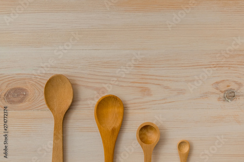 Empty wooden spoons on wooden background, copy space