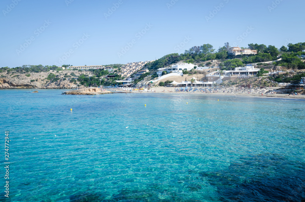 View of Cala Tarida with rocks in turquoise sea water, Ibiza island, Spain