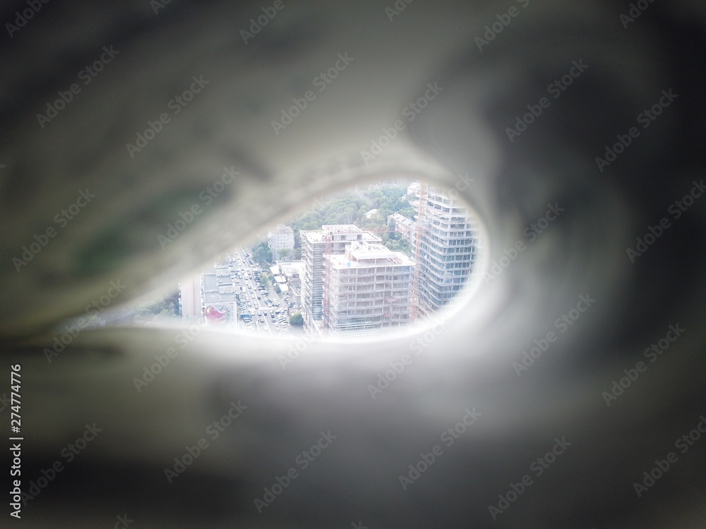 Fototapeta premium Stack of american dollars on urban background. A lot of American dollars on the background of urban real estate. American dollars on the background of a house under construction.