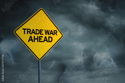 Yellow road sign with text of trade war ahead