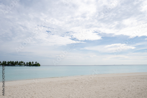 Wide sandy beach on a tropical island in Maldives