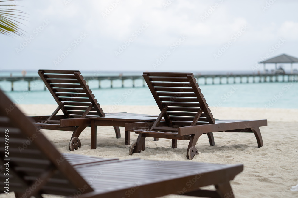 Beautiful beach with chaise lounge with ocean landscape