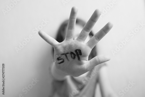 Little girl protects herself with a hand on the palm of her inscription 