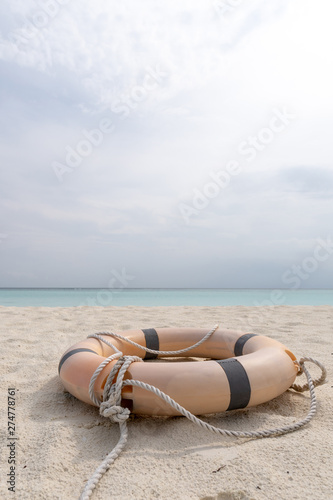 Lifebuoy and rope lie on the beach of a tropical beach.