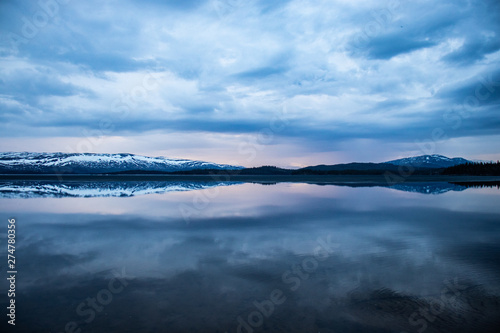 Majavatn in the north of Norway tranquil water with reflection of mountains