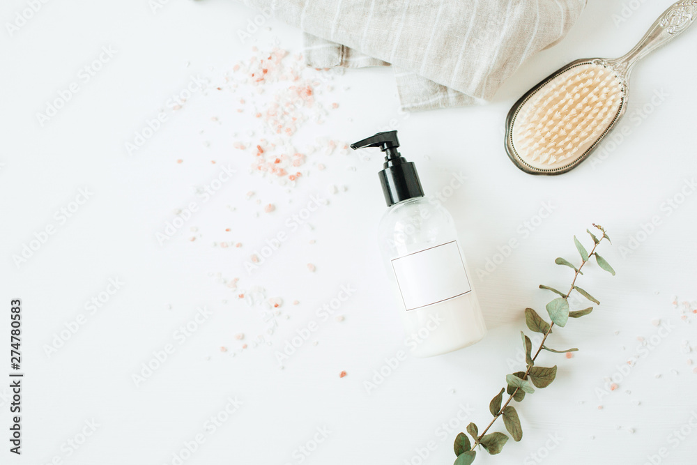 Healthcare spa concept with copy space liquid soap bottle, eucalyptus, hairbrush on white background. Flat lay, top view beauty lifestyle composition. - obrazy, fototapety, plakaty 