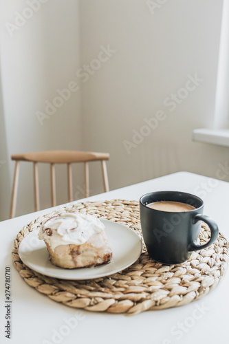 Morning breakfast with coffee with milk and dessert on white table. Minimal food composition.