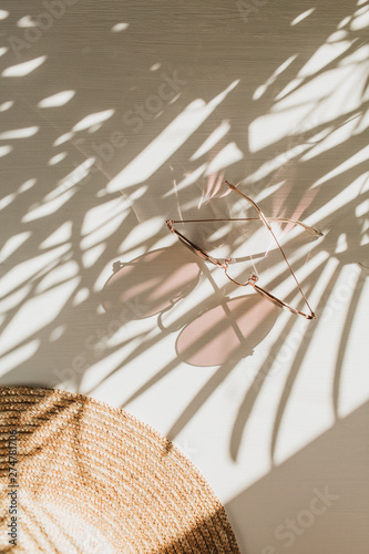 Fashion composition with women's accessories on white background. Sunglasses, straw hat on white background. Flat lay, top view trendy french style lifestyle blog concept.