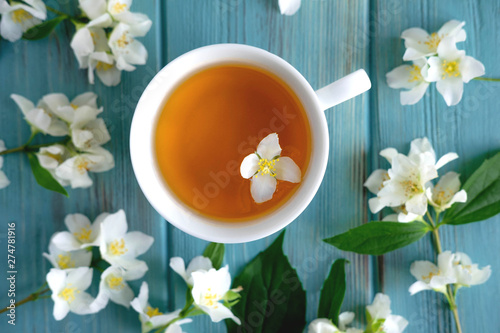 Jasmine tea on a blue wooden background. Relaxing jasmine tea. Aromatic teas for relaxation and health