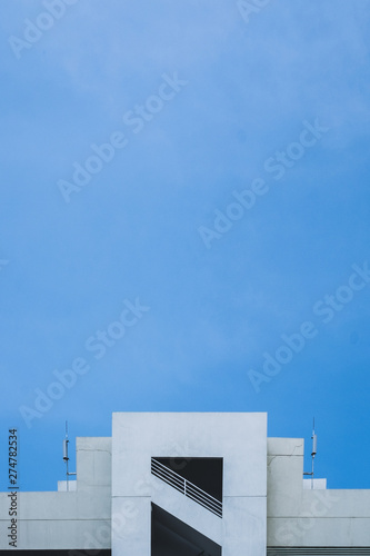 Abstract image of looking up at modern glass and concrete building.