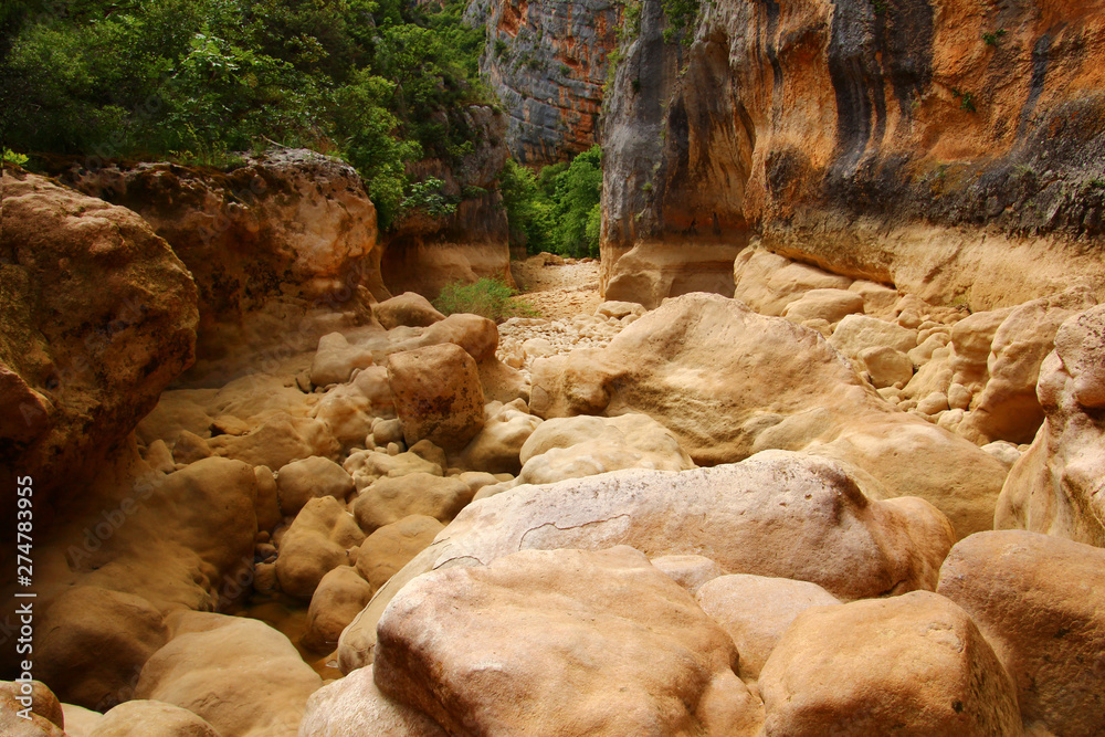 A steep mountain dry river slot canyon. Steep rock cliff on all sides. Croatia, Canyon Čikola A steep mountain dry river slot canyon. Steep rock cliff on all sides. Croatia, Canyon Čikola