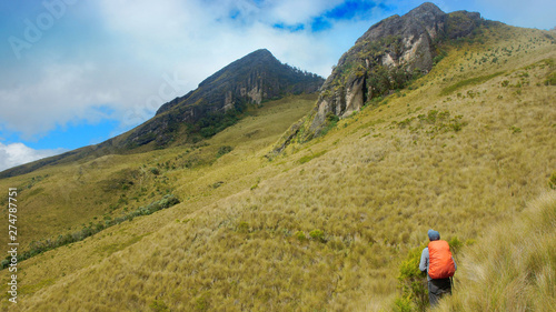 Lonely tourist walking towards the summit Pasochoa (extinct volcano) near the city of Quito / Ecuador