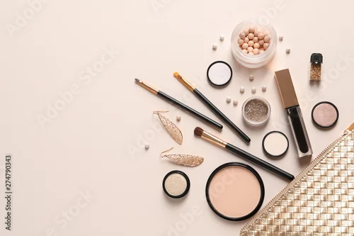 Obraz Cosmetic bag and different luxury makeup products on color background, flat lay. Space for text