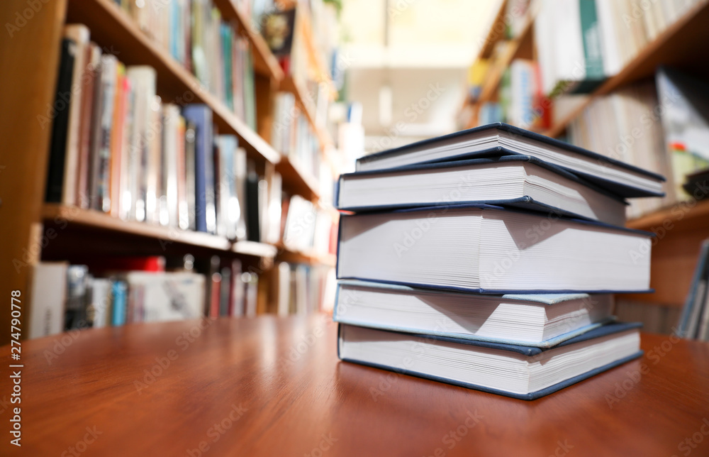 Stack of books on table in library. Space for text Stack of books on table in library. Space for text