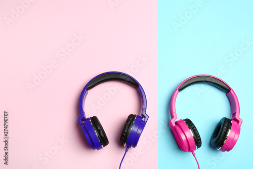 Stylish modern headphones on color background, flat lay. Space for text